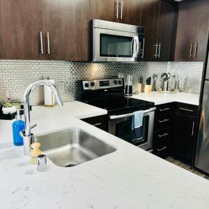 a kitchen with a sink and a stove at Stylish Hollywood Blvd. w/ FREE Parking in Los Angeles