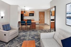 ein Wohnzimmer mit einem Sofa und einem Tisch in der Unterkunft Candlewood Suites Louisville North, an IHG Hotel in Clarksville