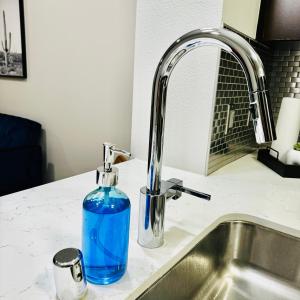a blue bottle sitting on a kitchen counter next to a sink at Stylish Hollywood Blvd. w/ FREE Parking in Los Angeles