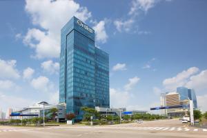 a tall blue building with a sign on it at Orakai Songdo Park Hotel in Incheon