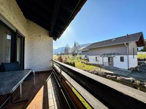a balcony with a view of a house at FEWO Dorfglück in Oberstaufen