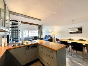 a kitchen and living room with a table and chairs at FEWO Dorfglück in Oberstaufen +11 photos