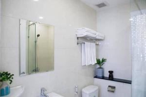 a bathroom with a sink and a mirror and a toilet at Angie's Home in Ho Chi Minh City