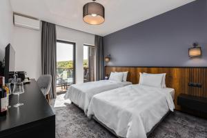 Rúm í herbergi á Hotel Qvevrebi