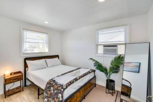 a bedroom with a bed and a potted plant at NEW 3 BR Vacation House Close to Golden Nugget in Atlantic City