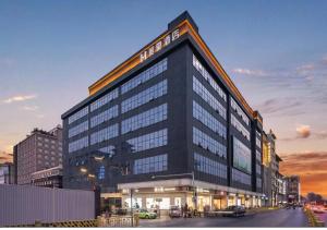 a tall black building with a sign on it at Mehood Theater Hotel, Zhonglou Metro Station Huimin Street in Xi'an