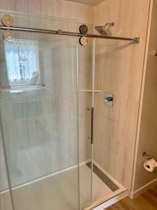 a shower with a glass door in a bathroom at Urban SLO Living- 1 mile from downtown in San Luis Obispo