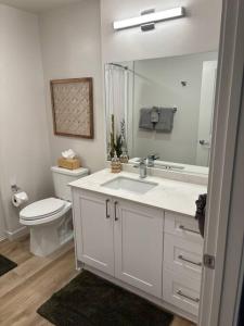 a white bathroom with a sink and a toilet at Urban SLO Living- 1 mile from downtown in San Luis Obispo