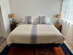 a bedroom with a large bed with two lamps at Urban SLO Living- 1 mile from downtown in San Luis Obispo
