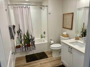 a bathroom with a toilet and a sink and a shower at Urban SLO Living- 1 mile from downtown in San Luis Obispo