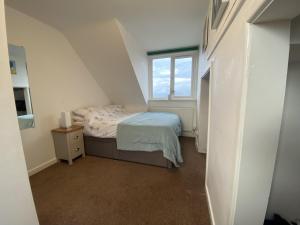 a small bedroom with a bed and a window at Beautiful cottage in tranquil location with large garden in Woolacombe