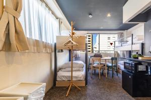 a room with a loft bed and a dining room at HOTEL HARE BARE 3min walk from Kiba Station in Tokyo