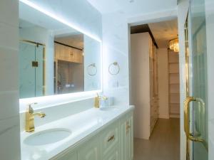 a bathroom with a sink and a mirror at Beachfront Seaview Apartment in Male City