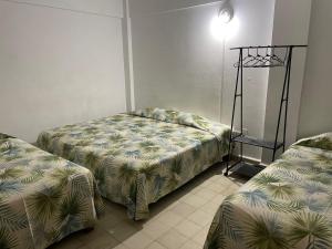 Un pat sau paturi într-o cameră la Hotel zócalo abuelos