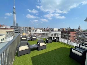 a balcony with chairs and a view of a city at La Terrasse Higashikomagata - Vacation STAY 17380v in Tokyo