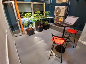 a room with a table with a laptop and plants at Edificio Recoleta - Hoteles Recoleta in Buenos Aires