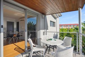 a patio with a table and chairs on a balcony at Applecross Riverside Apt in Perth