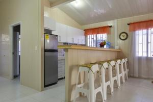 a kitchen with a counter with a row of stools at Tropical Coral in San Andrés