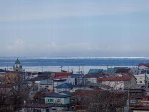 a city with buildings and the water in the background at Tabist Hotel Nemuro Kaiyoutei in Nemuro