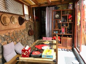 a room with a table with food on it at Lijiang Jayden Lodge臣安山居民宿 - Namaste in Lijiang
