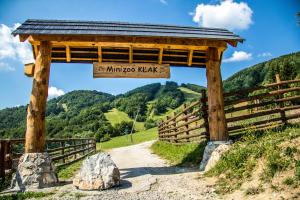 a wooden gazebo with a sign that reads minko ko yawn at Salaš Kľak in Fačkov