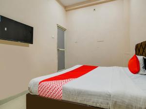 a bedroom with a bed and a flat screen tv at OYO Hotel Airport View in Indore