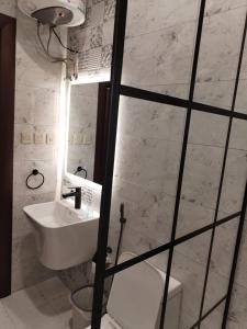 a white bathroom with a sink and a toilet at شقق الياسمين in Al Madinah