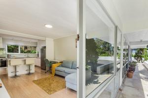 a living room with a couch and a table at Herne Bay 1BR Retreat in Auckland