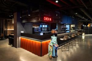 a bar in a restaurant with a skateboard on the counter at Moxy Halifax Downtown in Halifax