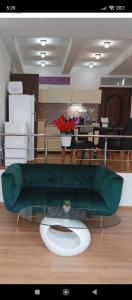 a room with a green couch and a table at LUX & Comfort in Košice