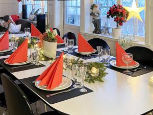 a table set with red napkins and red napkinsktop at 10 person holiday home in SYSSLEB CK in Sysslebäck