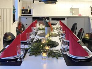 a long table with red napkins and candles on it at 10 person holiday home in SYSSLEB CK in Sysslebäck