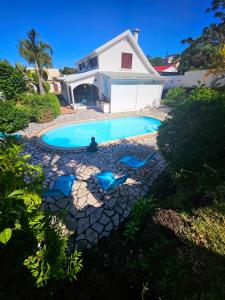 - une piscine en face d'une maison dans l'établissement Kaz Ô Flambloyant avec piscine privative, proche Grand'Anse, à Petite Île