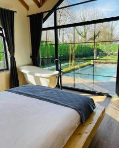 a bedroom with a bed and a view of a pool at Villa La Altragracia in Constanza