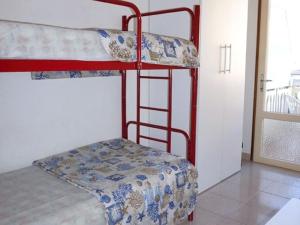 a bedroom with two bunk beds in a room at Cosy apartment with balcony in Porto Santa Margherita di Caorle
