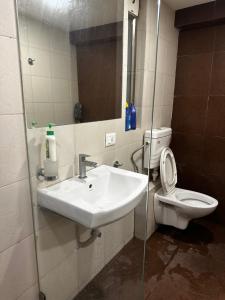a bathroom with a sink and a toilet at Jash hospitality in Surat