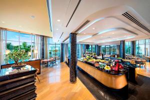 a dining room with a table with food on it at ITC Kohenur, a Luxury Collection Hotel, Hyderabad in Hyderabad