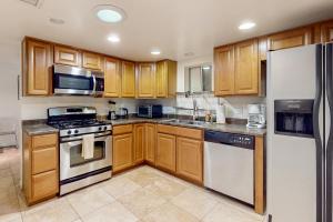 a kitchen with wooden cabinets and stainless steel appliances at Paradise in Phoenix in Phoenix