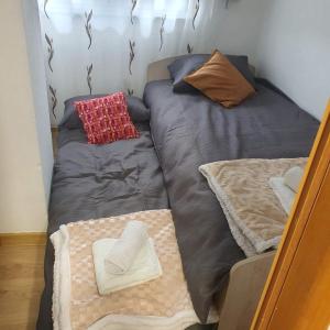 a bed in a room with two pillows on it at HOLIDAY HOUSE MARIC 