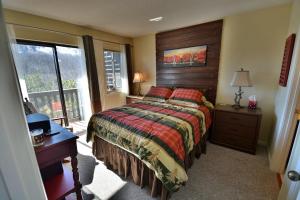 a bedroom with a large bed with a wooden headboard at Higher Altitude in Gatlinburg +30 photos