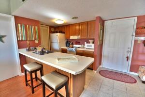 a kitchen with a sink and a counter with stools at Higher Altitude in Gatlinburg