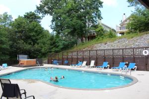 a group of people swimming in a swimming pool at Higher Altitude in Gatlinburg