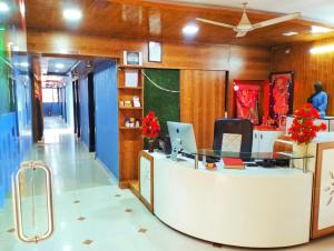 an office with a desk with a laptop on it at Balaji Hotel in Ahmedabad