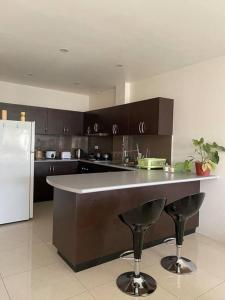 a kitchen with a counter and a refrigerator at Bula Bliss in Nadi