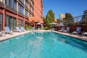 a swimming pool with chairs and a hotel at Four Points by Sheraton Memphis East in Memphis