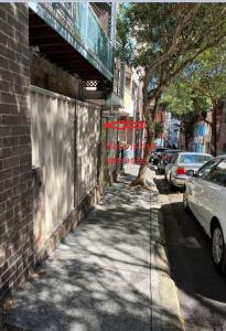a street with cars parked on the side of a building at Comfortable Studio+free parking for small car in Sydney