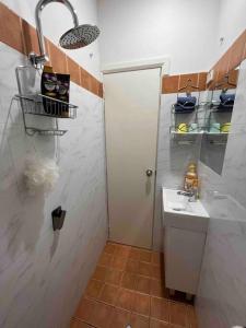 a small bathroom with a sink and a toilet at Comfortable Studio+free parking for small car in Sydney