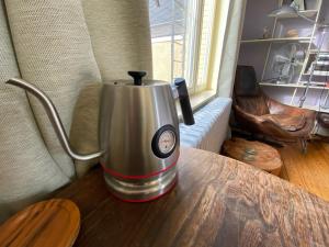 a coffee maker sitting on a wooden table at Lunatree in Mechelen