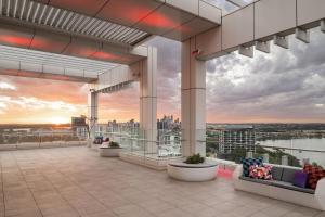 a rendering of the rooftop of a building with a sunset at Aloft Perth in Perth