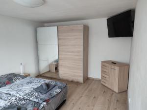 a bedroom with a bed and a dresser at Ubytování U Venci in Valtice